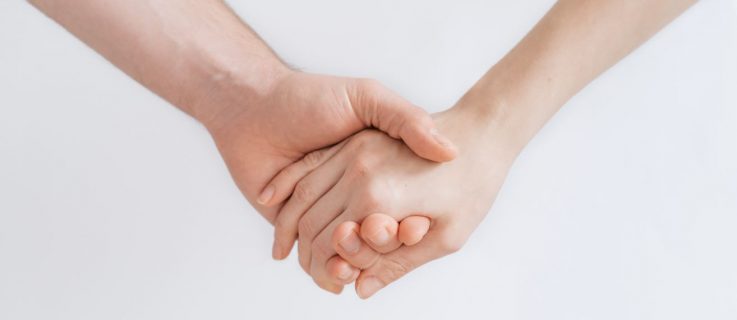 close up image of a couple holding hands